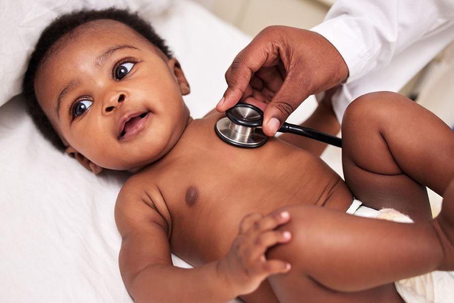 A baby receiving a heart screening with a stethoscope